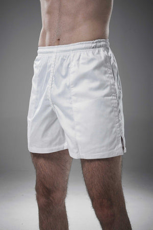 Man wearing white Optimum Auckland rugby shorts, angled front view on grey studio background - Optimum