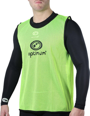 Fluorescent yellow mesh Optimum training bib with black logo worn by a man over black top, front view - Optimum