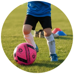 Small child kicking a football